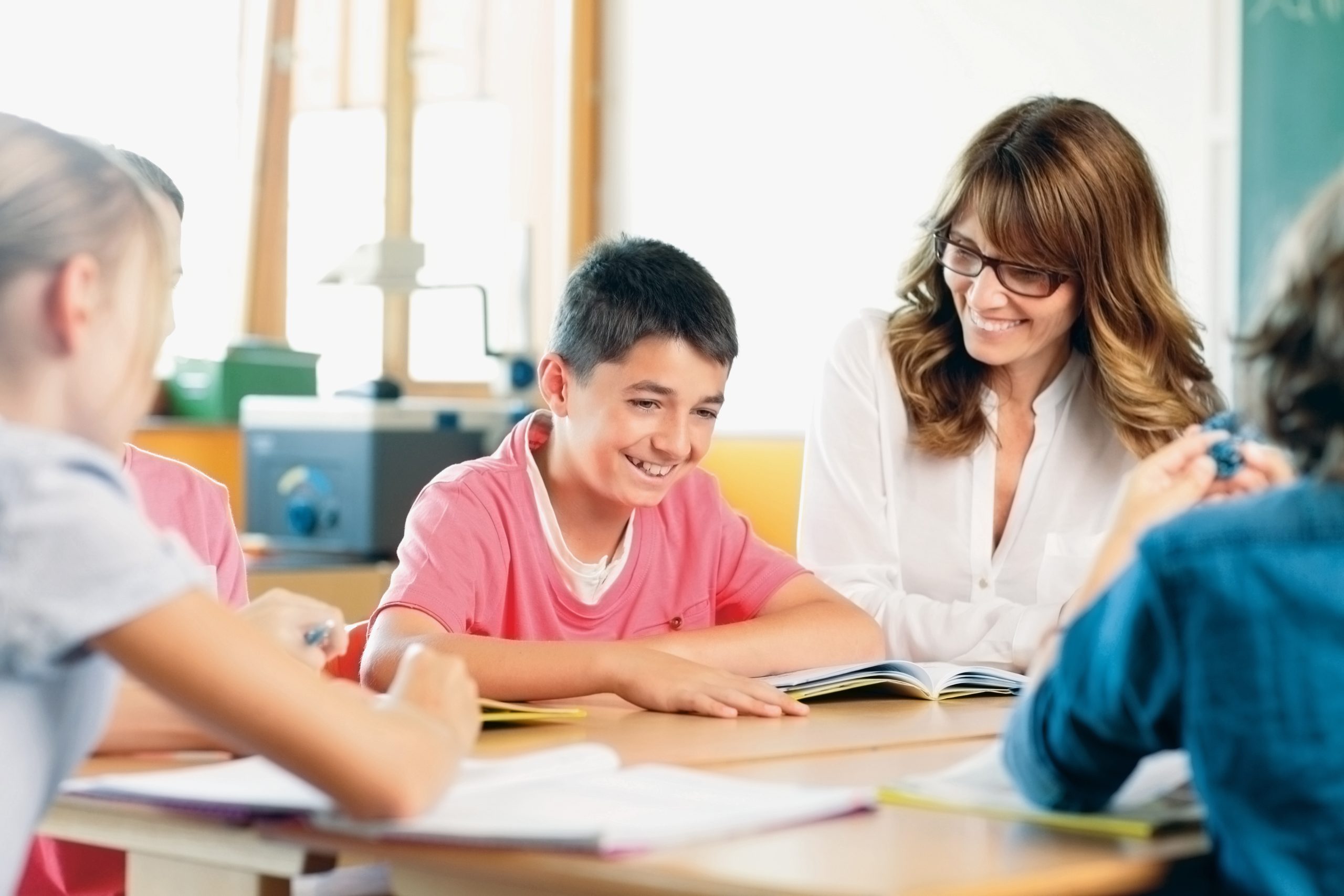 Teacher and student in a classroom at school.